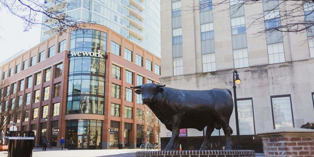 a statue of a bull in front of a building