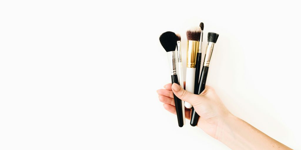 person holding black makeup brush