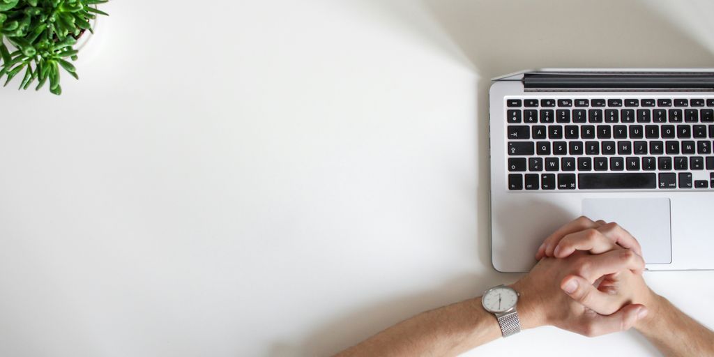 person wearing watch near laptop