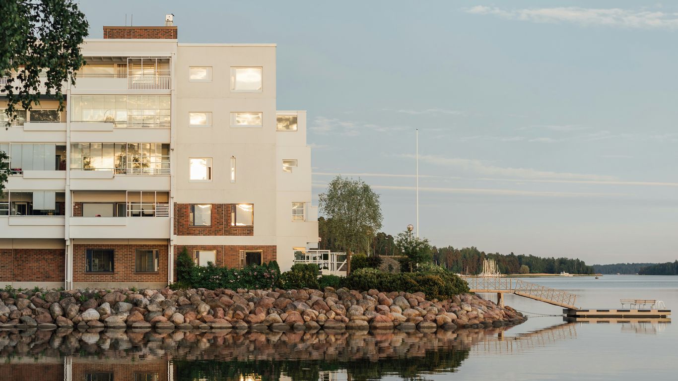 beige concrete building near body of water during daytime