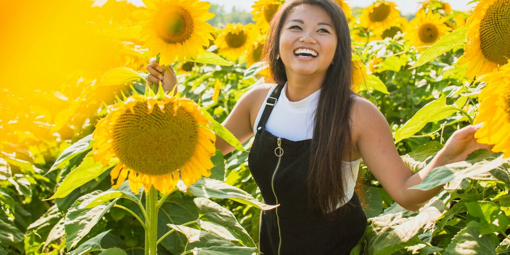 woman surrounded with sunflowers at daytime