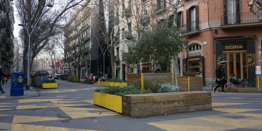 a city street with a planter on the side of the road
