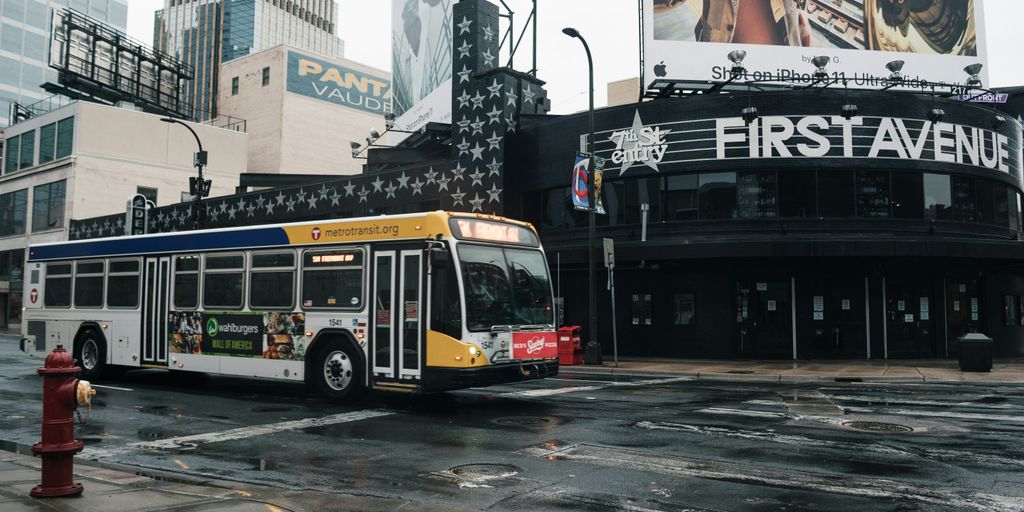 yellow and red bus on road during daytime