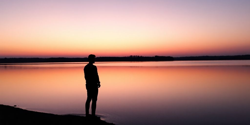 Person reflecting near calm water.