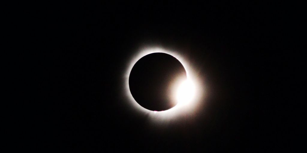 a solar eclipse is seen in the dark sky