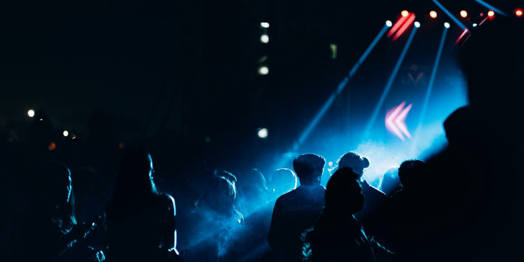 a crowd of people standing around a stage