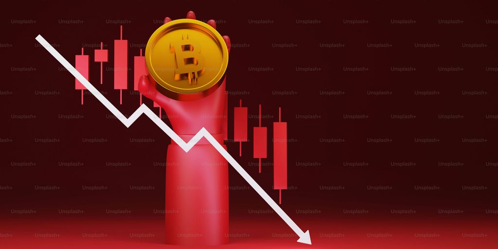 Hand holding a Bitcoin symbol with a downward trend line.