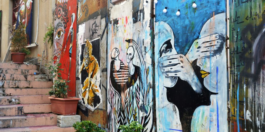 woman in black and white stripe shirt and blue denim jeans graffiti
