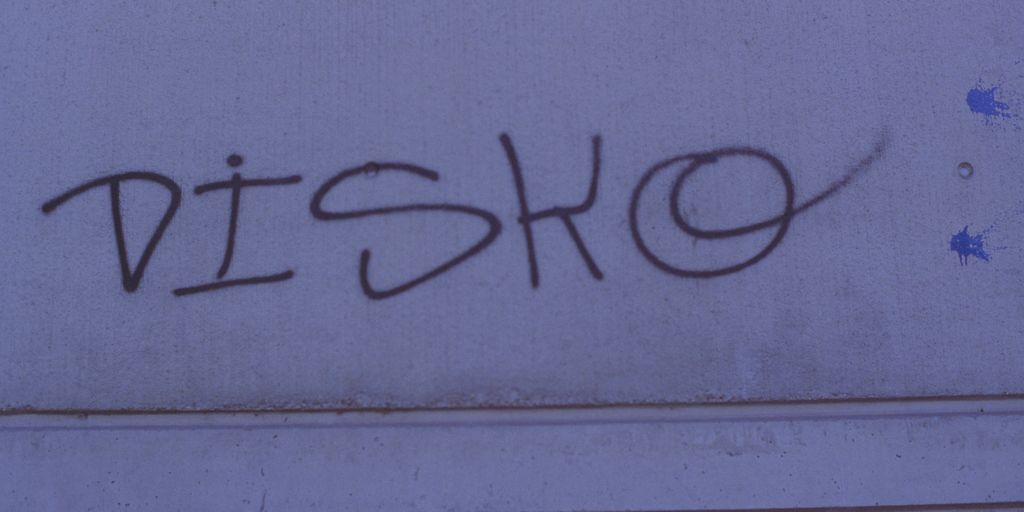graffiti on the side of a building with the word disco written on it