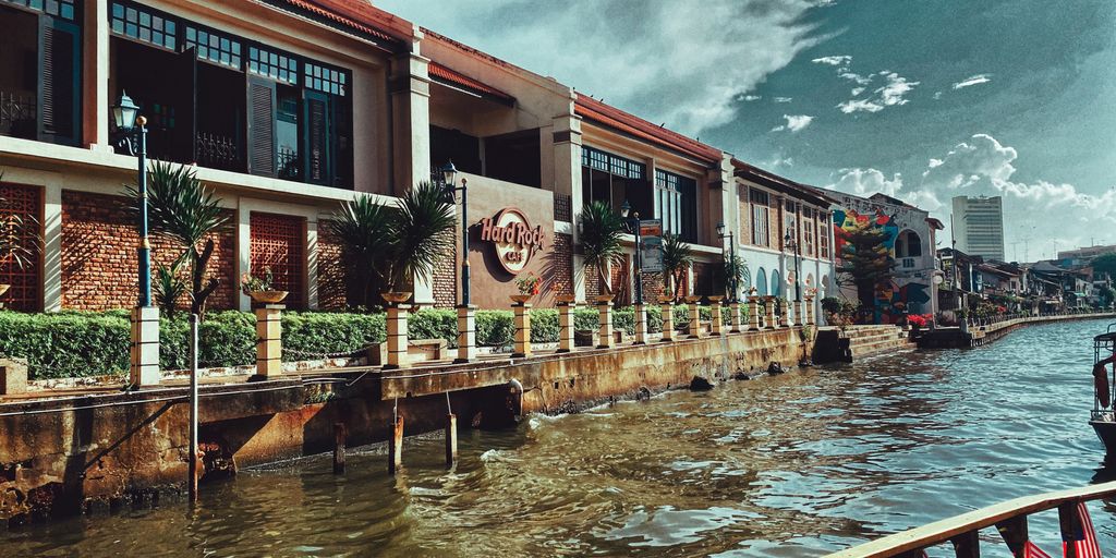 brown and white concrete building near body of water during daytime