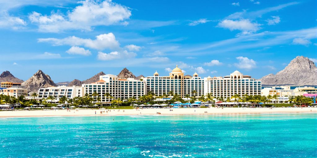 Dreams Resort Cabo with beach and palm trees.