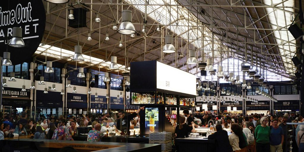 Time out market is bustling with people and activity.