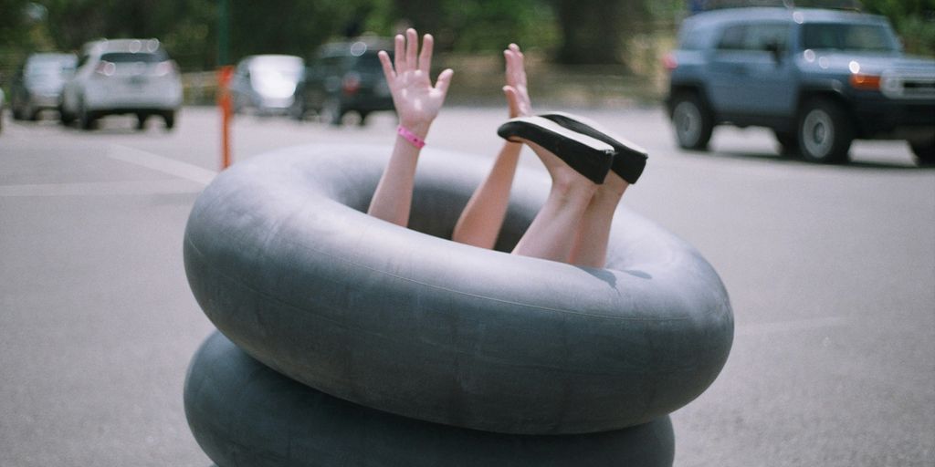 person sitting on inflatable rings