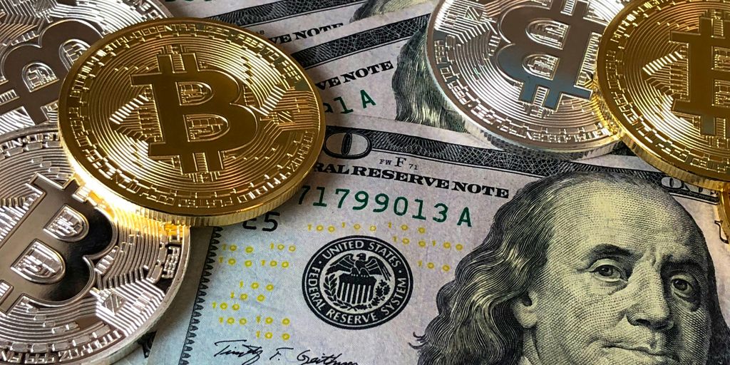 Stack of U.S. dollars and Bitcoin coins on a surface.