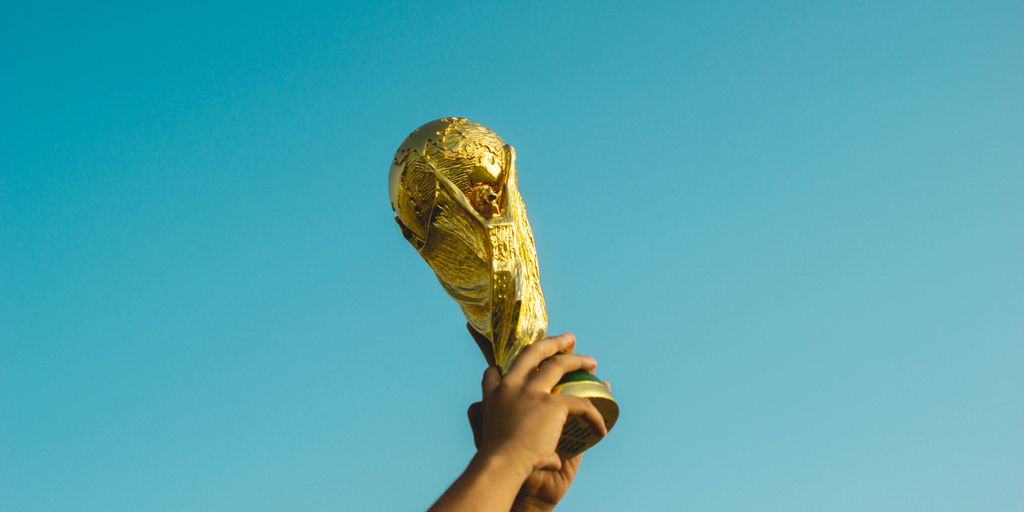 person holding gold trophy