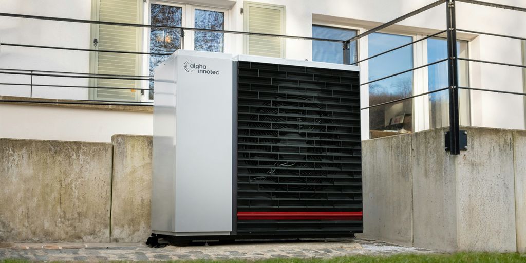 a white air conditioner sitting in front of a building