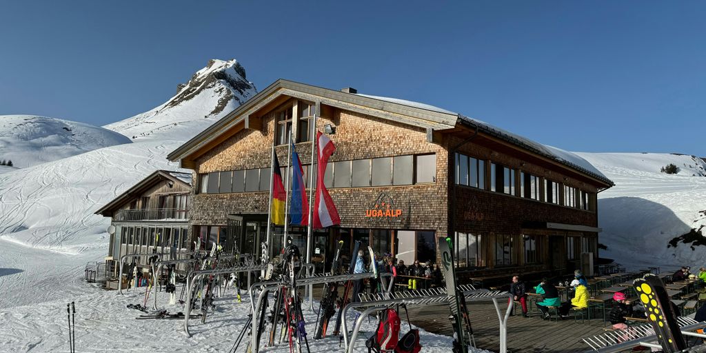 a group of people standing outside of a ski lodge