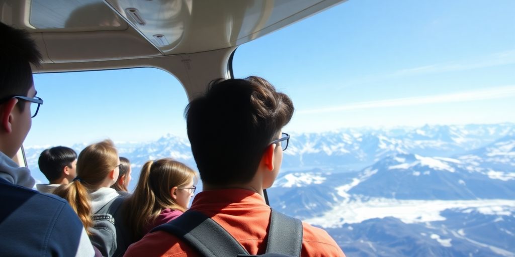 Students in a small plane flying over Alaskan mountains.