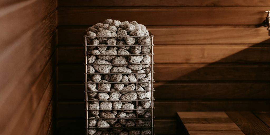 a basket filled with rocks sitting on top of a wooden table