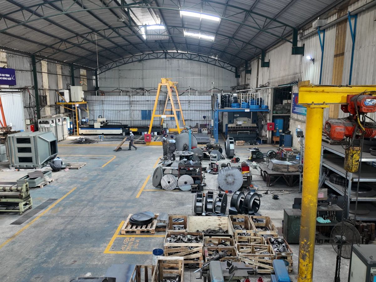 Spacious industrial workshop filled with machinery and equipment.