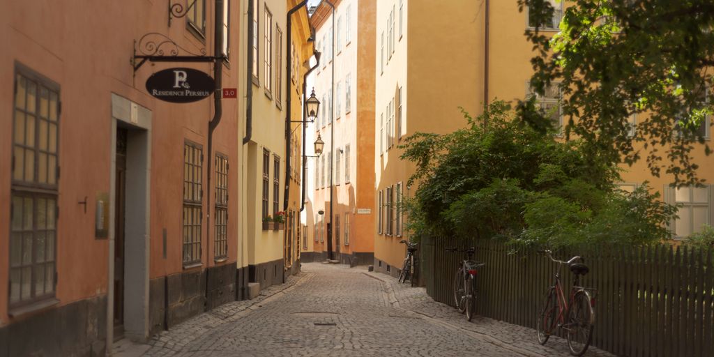 a cobblestone street with a bicycle parked on the side of it