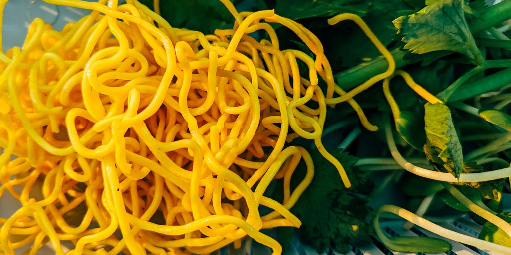 a pile of yellow noodles sitting on top of a table