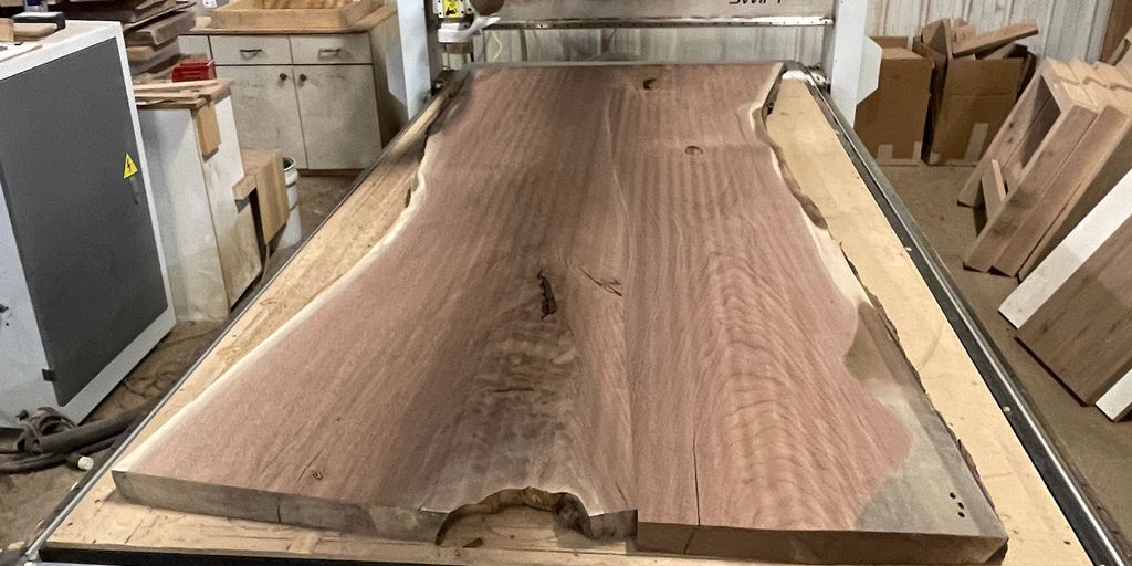 A woodworking machine with a large slab of wood.