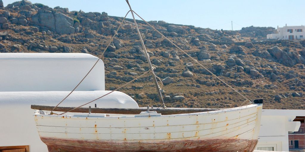white and brown boat on water during daytime