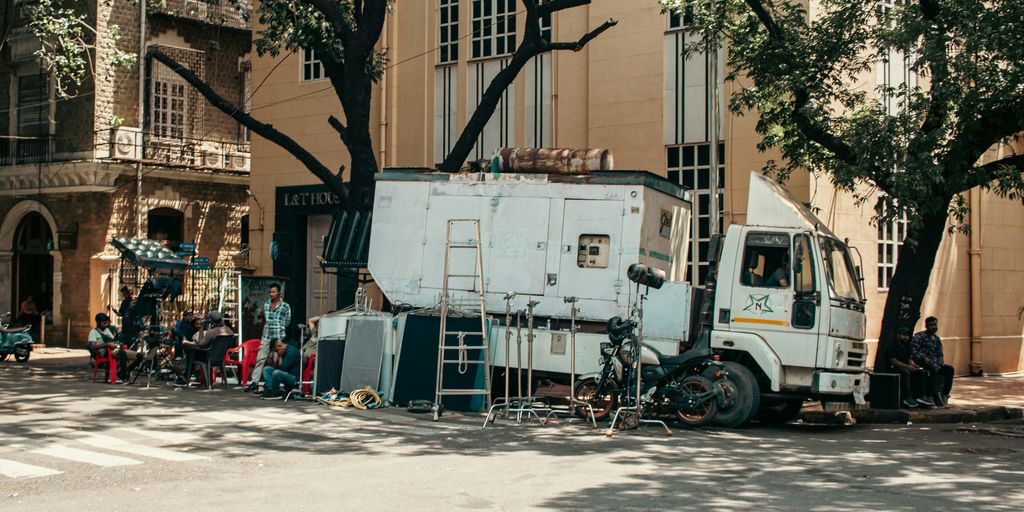 A truck with equipment parked by a building.