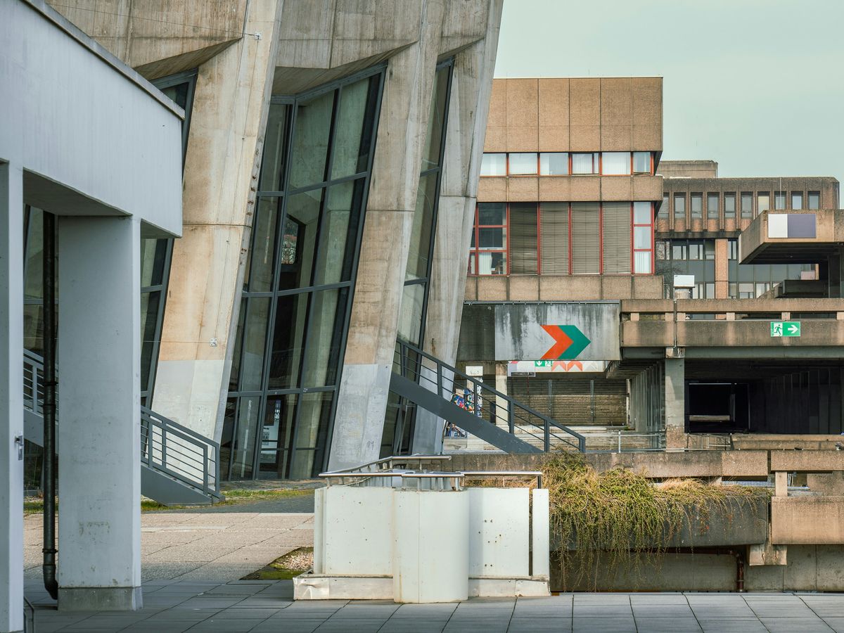 a building with a green arrow on the side of it