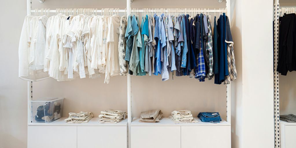 white and blue shirts hanging on white wooden cabinet