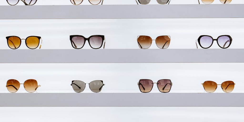 black framed sunglasses on white surface