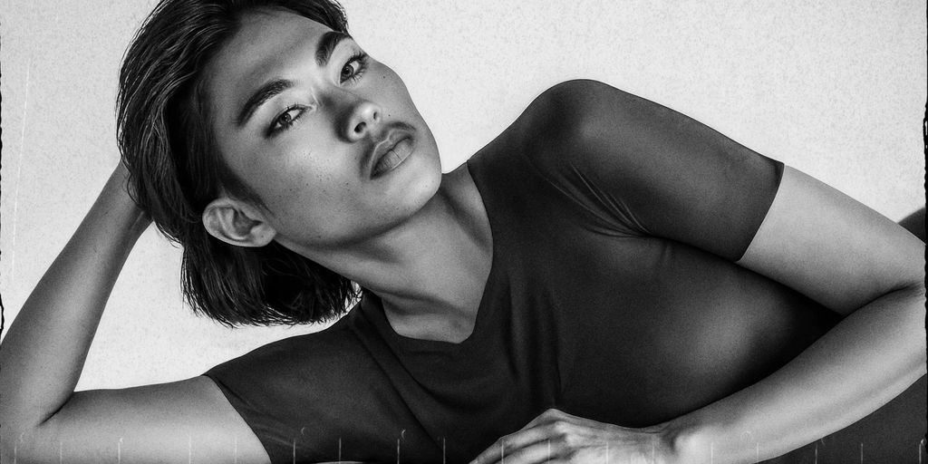 Ai generated portrait of a model laying with hand on head