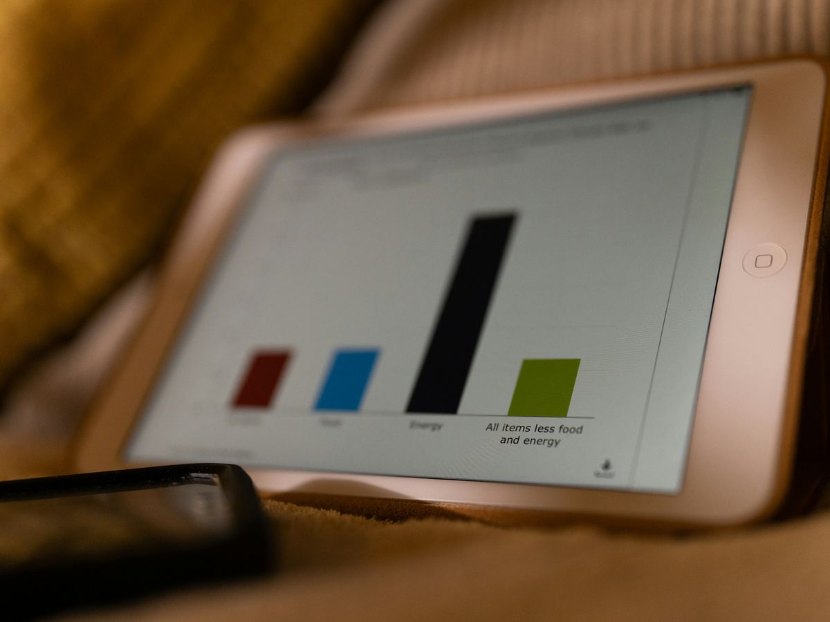 a tablet computer sitting on top of a bed