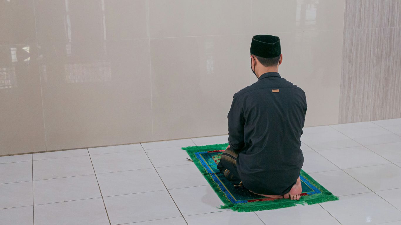 man in black long sleeve shirt sitting on green mat