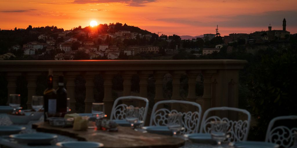 a table with chairs and a sunset