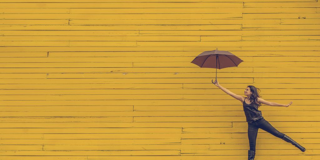 woman holding brown umbrella