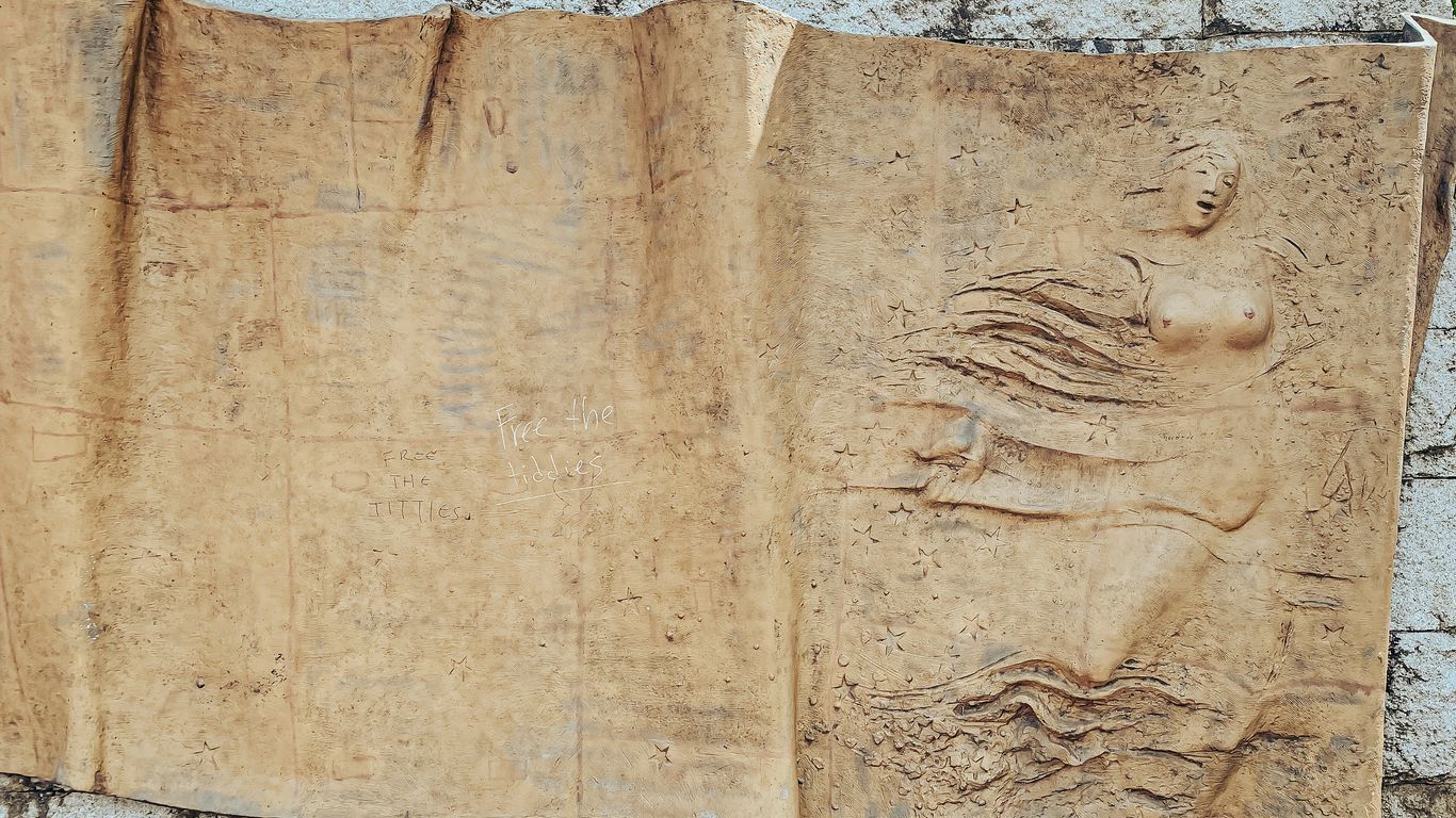 a stone carving of a man and woman