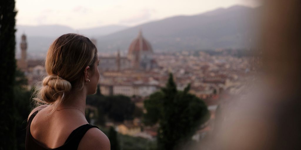 a woman looking out over a city