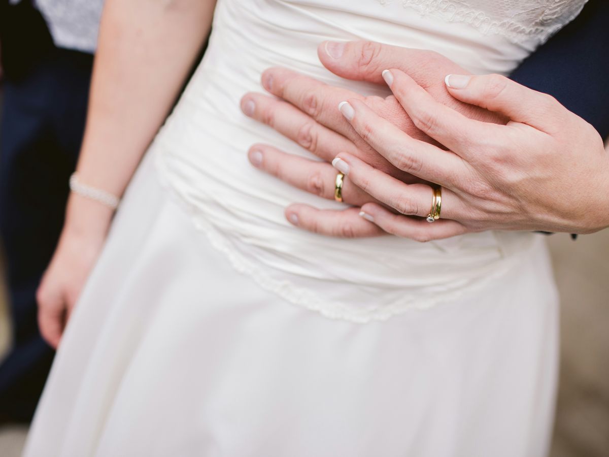 man embracing woman waist