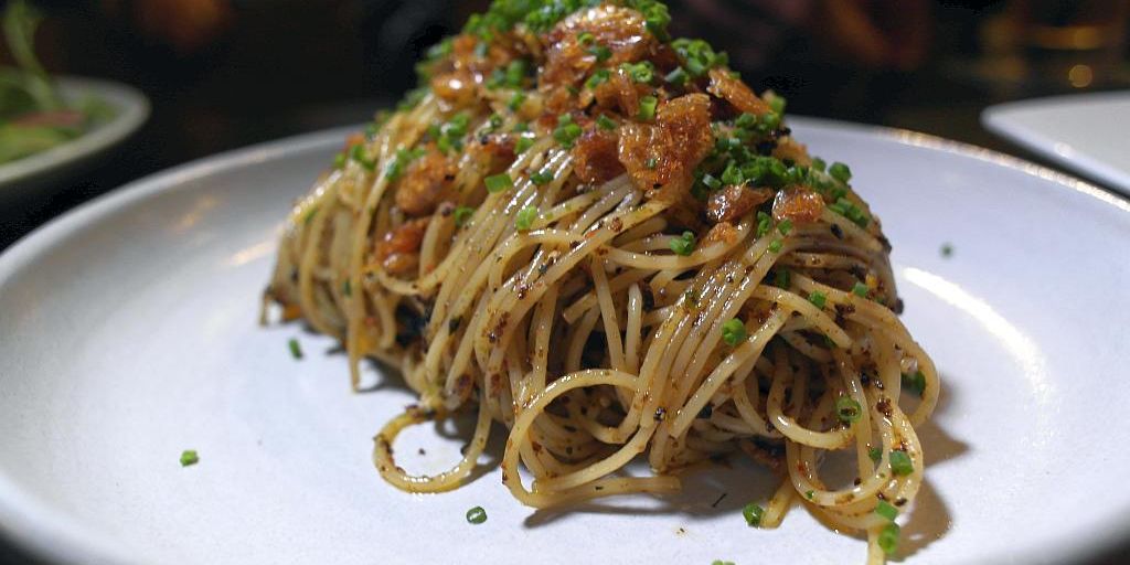 swimmer eating pasta poolside