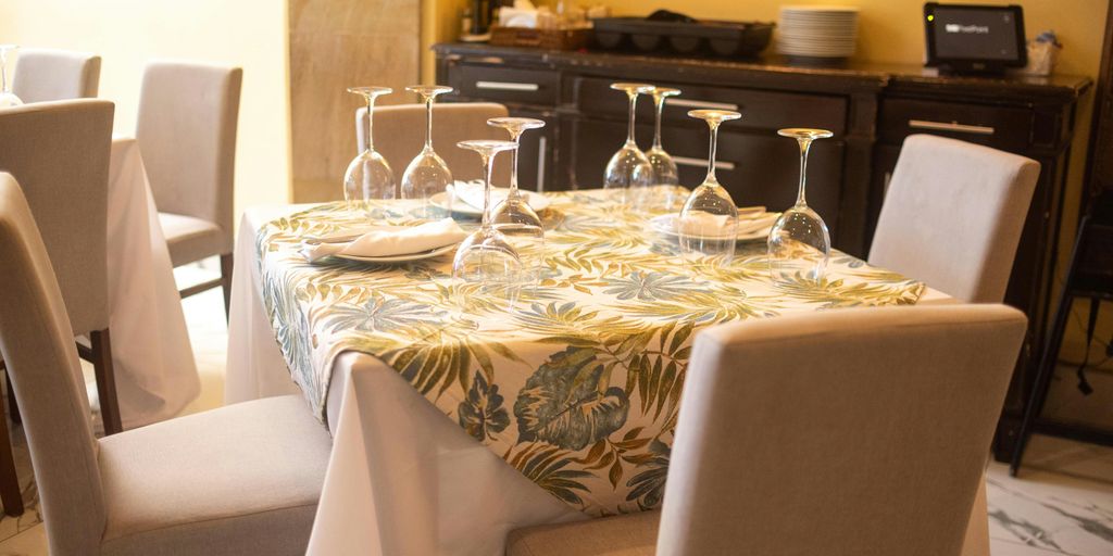 A dining room with a table and chairs