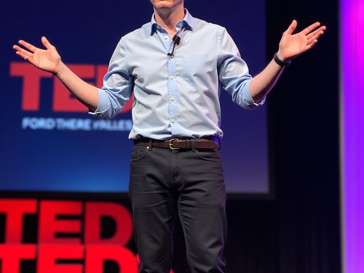 A person speaking on stage at a TED event.