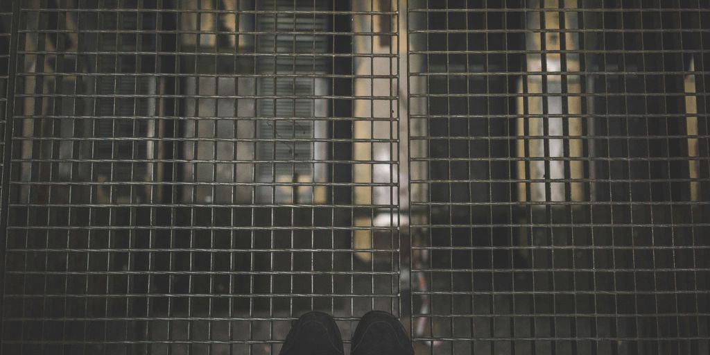 person standing on gray mesh surface