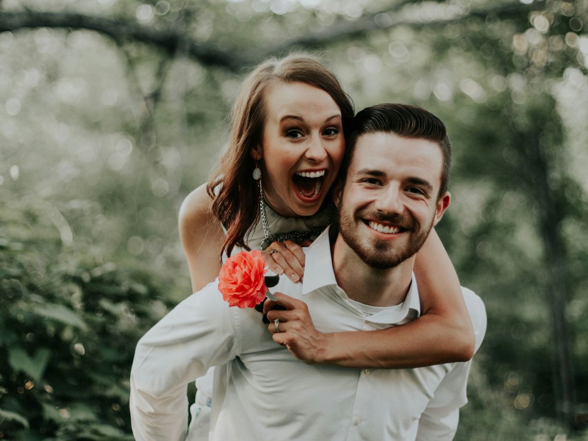 Woman Riding On Back Of Man