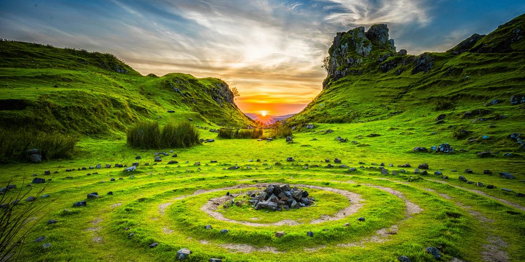 green grass field during sunset
