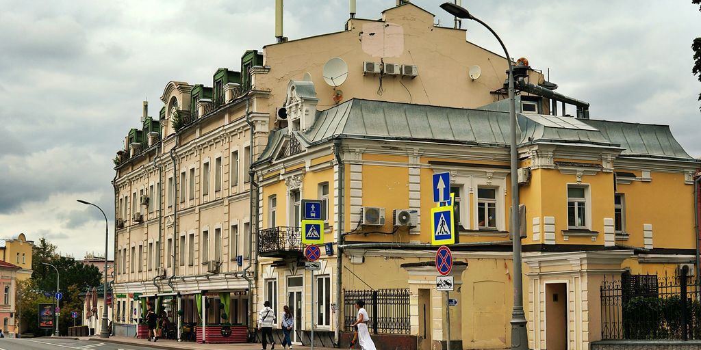 A yellow building with multiple windows and balconies.