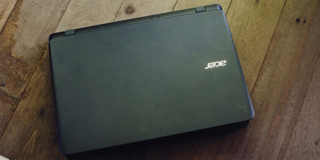 a laptop computer sitting on top of a wooden floor