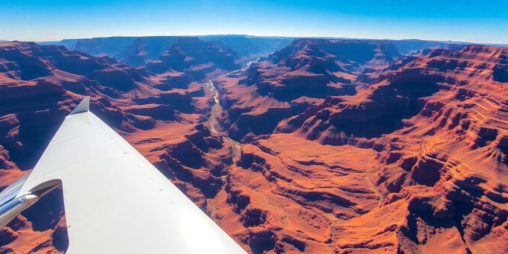 A small tour airplane flying over the Grand Canyon.