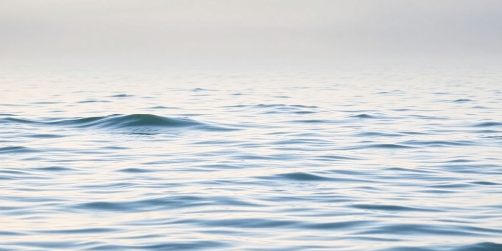 Serene landscape with calming waves and lush greenery.